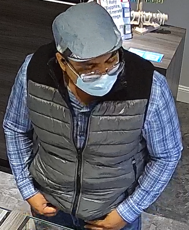 A robbery subject wearing a vest and long sleeves.