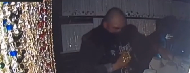 Image of burglar stealing jewelry.