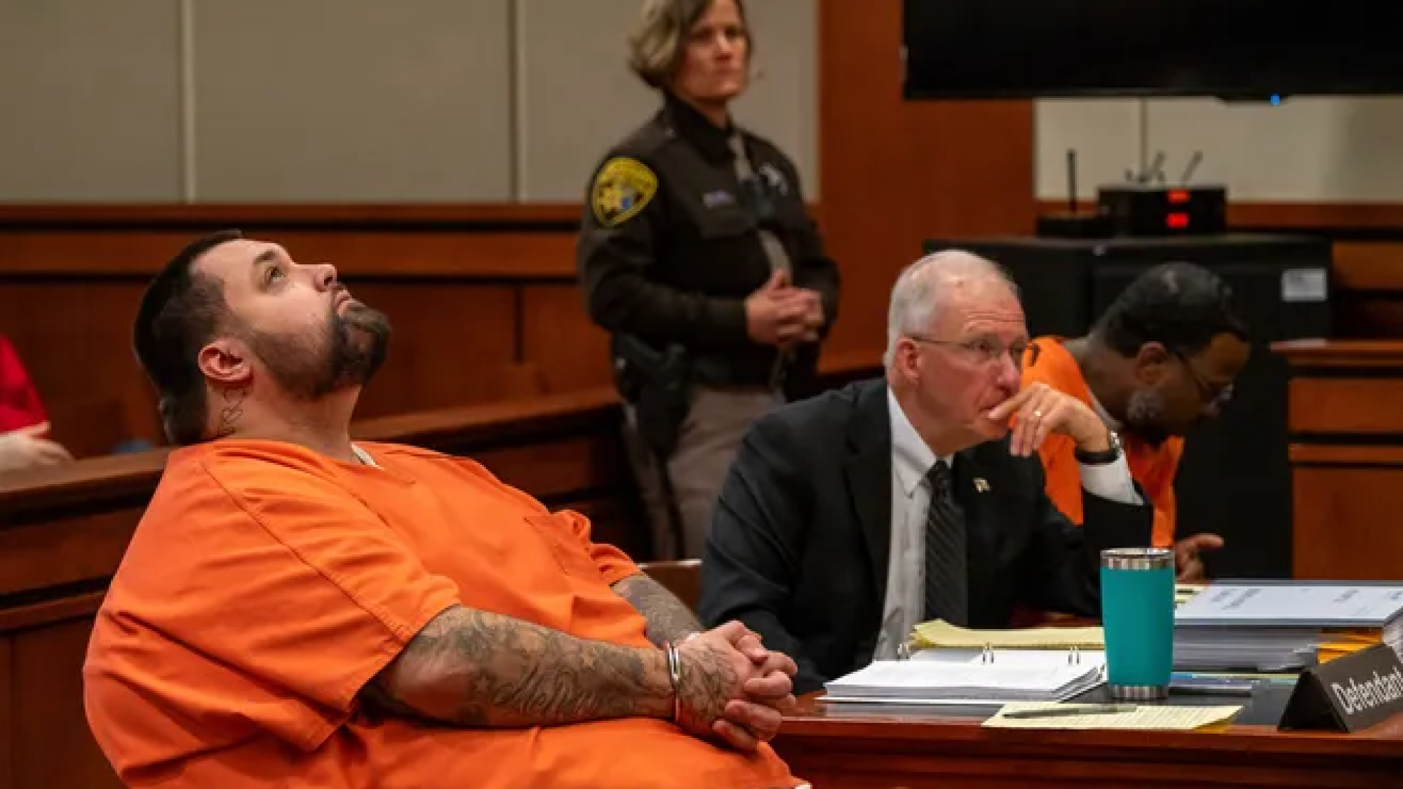 Two men sitting at table in court